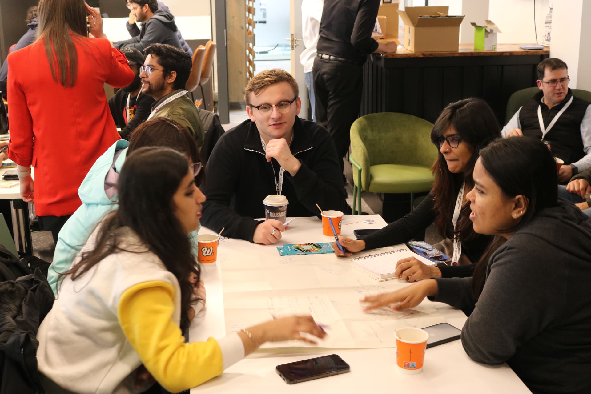 Participants collaborating over sketches and notes